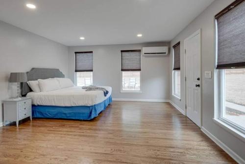 a bedroom with a bed and two windows at Oasis Of Nashville, With A Pool And Hot Tub ! in Nashville
