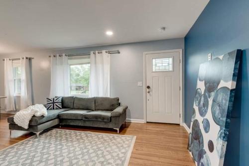 a living room with a couch and a blue wall at Oasis Of Nashville, With A Pool And Hot Tub ! in Nashville