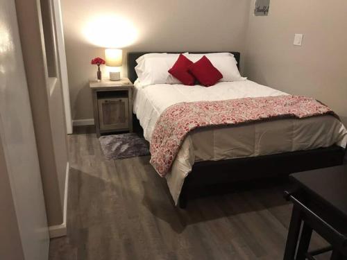 a bedroom with a large bed with red pillows at North Valley Studio - Near Balloon Fiesta Park in Albuquerque