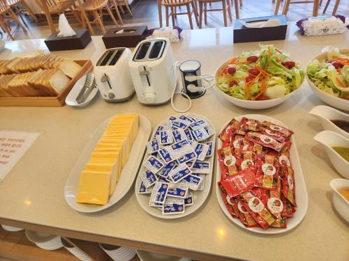 a table with plates of food and bowls of food at H avenue Kijang Ilgwang in Busan