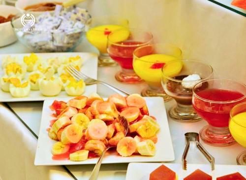 two plates of food on a table with drinks at Hotel Marbella in Punta del Este