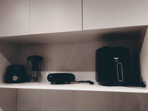 a kitchen shelf with appliances on top of it at Loft 132 Industrial luxury in Mogi das Cruzes