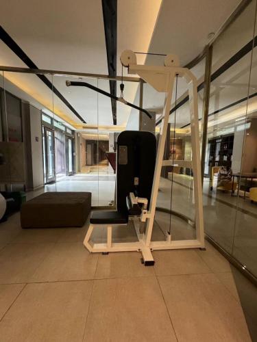 a room with a gym with a chair and a couch at Orange Hotel Beijing Temple of Heaven North Gate in Beijing