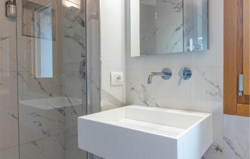 a white bathroom with a sink and a shower at Lovely Home In Passo Del Cerreto in Cerreto Laghi