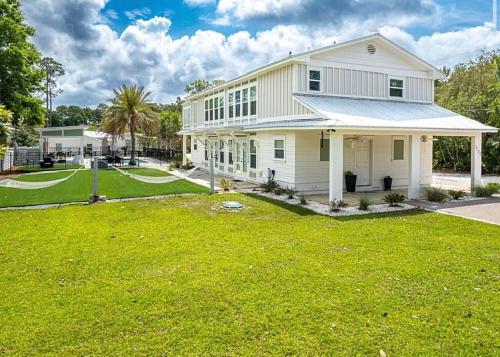 a white house with a large yard at The Retreat at Santa Rosa Beach Bungalow C in Destin