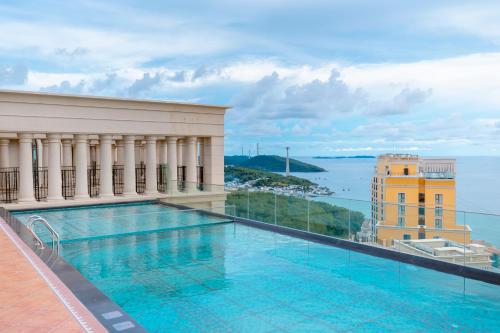 a swimming pool on a building with a view of the water at The Hill Apartment - Phú Quốc - Firework & Ocean View in Phu Quoc