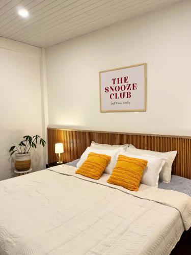 a bedroom with a bed with two yellow pillows at Yellow Stay in Āīzawl