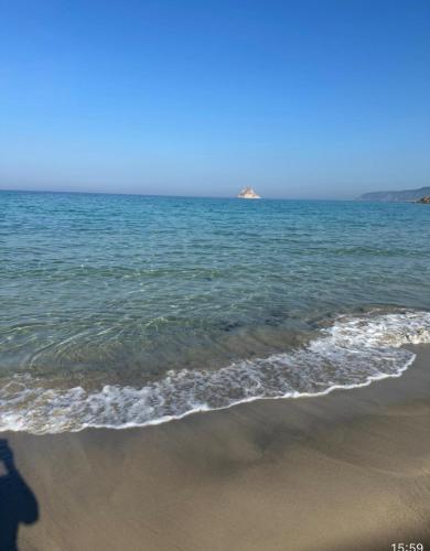 a person standing on the beach near the water at Villa Sounine Rafraf in Bizerte