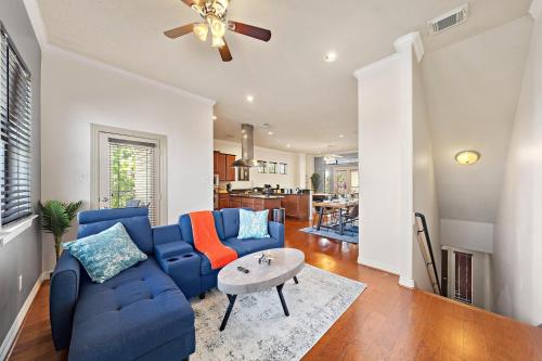 a living room with a blue couch and a table at Near Dt, Heights, Washington Wifi Games Bbq in Houston