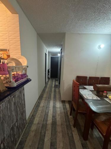 a dining room with a table and a hallway at Double bedroom TV cabinet in Soacha