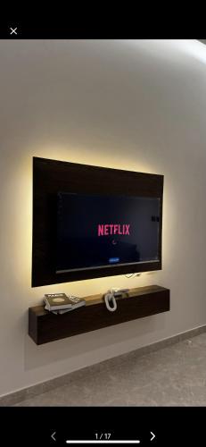 a flat screen tv sitting on a wall at شقة مخدومة VIp in Hafr Al Baten