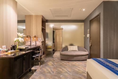 a hotel room with a bed and a vanity and a sink at A&EM Phan Boi Chau in Ho Chi Minh City