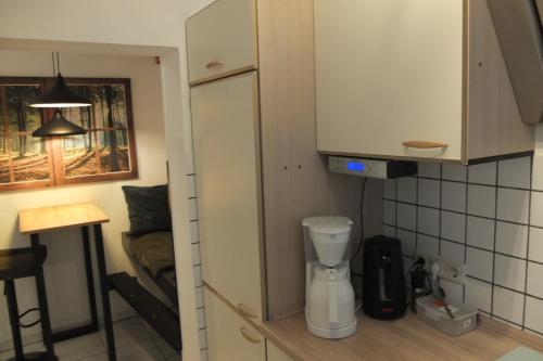 a kitchen with a white refrigerator and a table at FEWO Bad Laasphe in Bad Laasphe