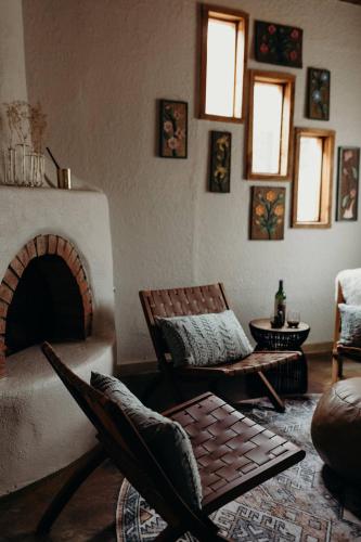 a living room with two chairs and a fireplace at Stay Old Town Road in Albuquerque