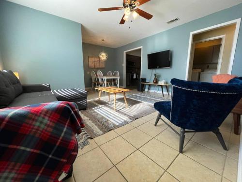 a living room with a couch and chairs and a tv at Full Kitchen, Beautiful & Brilliant Apt B in College Station