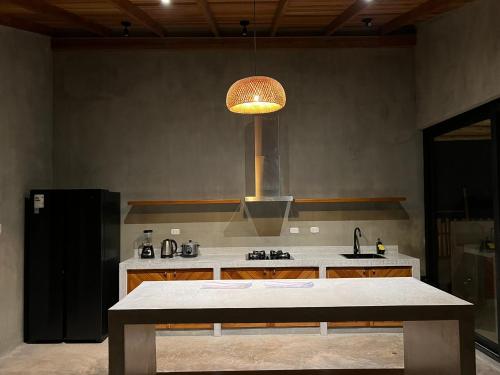 a kitchen with a sink and a stove top oven at La Morada - Casa de playa frente al mar en Estreno in Canoas De Punta Sal