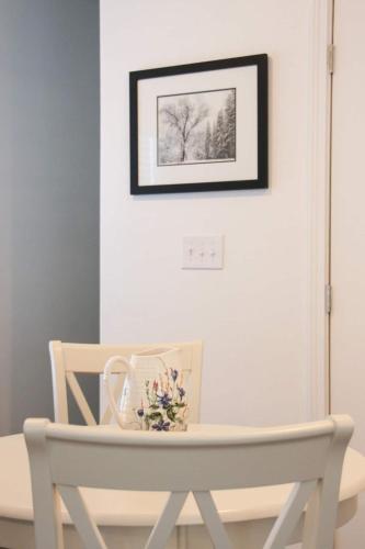 a white table and chairs with a picture on the wall at Outstanding Views Just North Of Durango in Hermosa