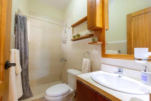 a bathroom with a sink and a toilet and a shower at Beachfront Cadaques Smart Tv Fullkitchenrest in Bayahibe