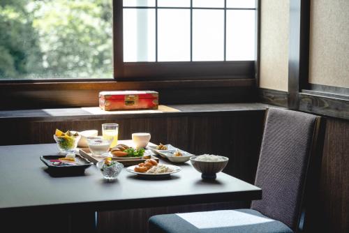 a table with plates of food on top of it at Shikishimaso in Higashikawa