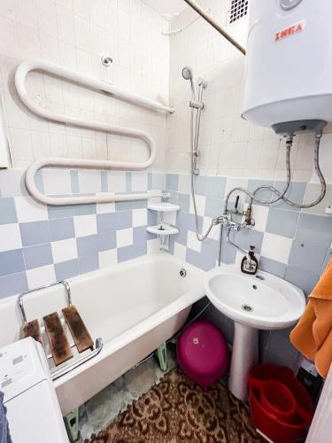 a bathroom with a bath tub and a sink at Cozy Seaside Apartment in Lahemaa in Loksa