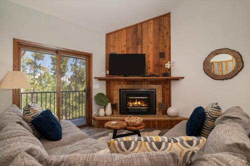 a living room with a couch and a fireplace at 10 min to Resort! Amazing Views & Sauna! in Winter Park
