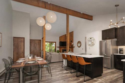 a kitchen and living room with a table and chairs at 10 min to Resort! Amazing Views & Sauna! in Winter Park