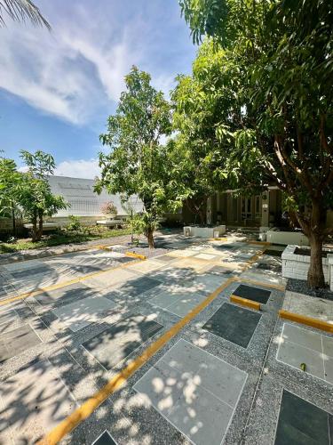 an empty parking lot with trees and a building at The Pudina Stay Probolinggo 