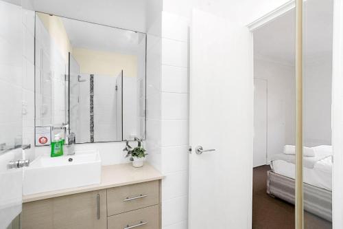 a bathroom with a sink and a mirror at 134 North Perth Nest for 4 parking in Perth