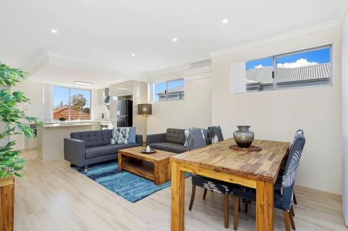 a living room with a table and a couch at 134 North Perth Nest for 4 parking in Perth