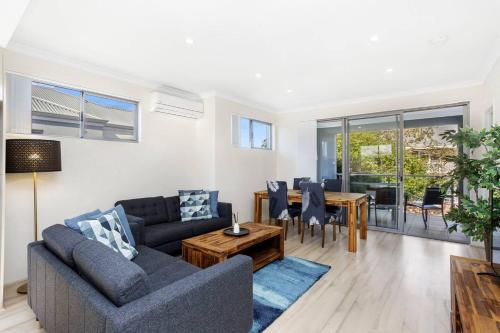 a living room with a couch and a table at 134 North Perth Nest for 4 parking in Perth