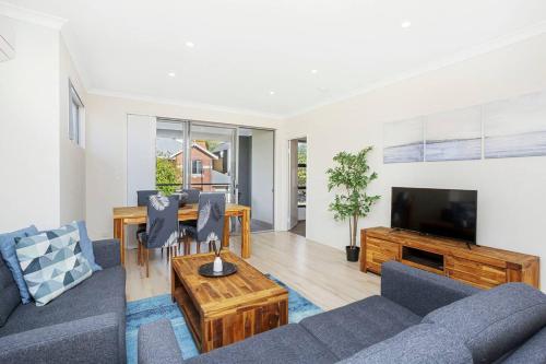 a living room with a couch and a table at 134 North Perth Nest for 4 parking in Perth