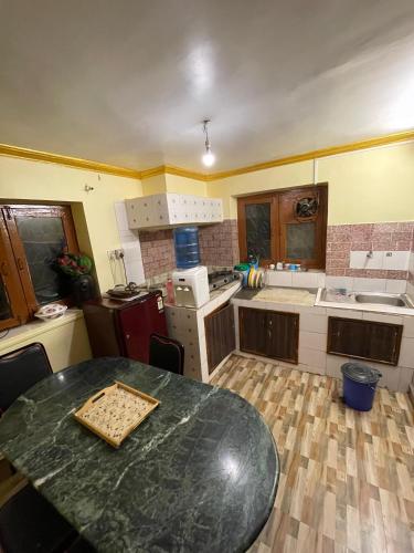 a kitchen with a table in the middle of it at Deepjyoti Inn in Pashupatināth