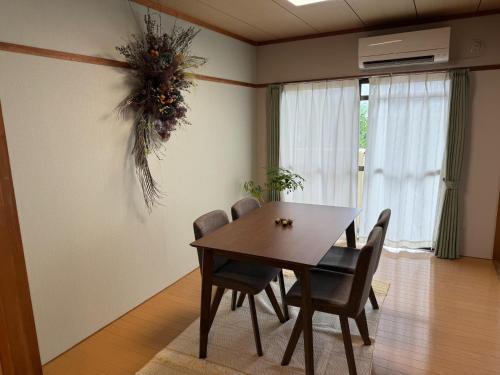 a dining room with a wooden table and chairs at Uemura Building 202 - Vacation STAY 19716 in Kirishima