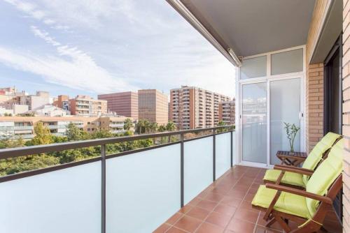 a balcony with two chairs and a view of the city at New Apartment With Private Rooftop in Hospitalet de Llobregat