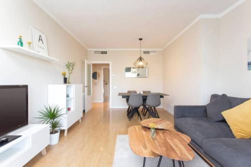 a living room with a couch and a table at New Apartment With Private Rooftop in Hospitalet de Llobregat