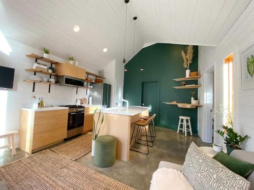 a kitchen and living room with a green wall at Private Oasis! Cozy & Close to Everything! in Portland