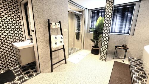 a bathroom with a shower and a sink and a mirror at Soho House Old Town Bangkok in Bangkok