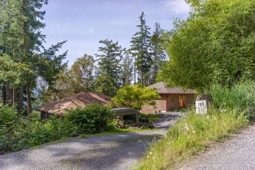 a house with a van parked next to a road at Beautiful Waterviews, Pet-friendly, Close To Town in Eastsound