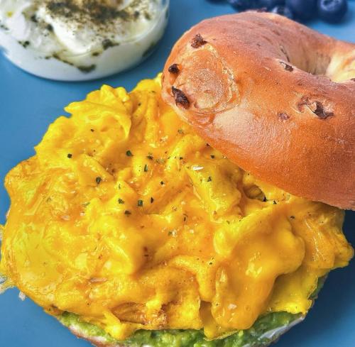 a close up of an omelet with a bagel on top at Zhangjiajie Wangyi Inn in Zhangjiajie