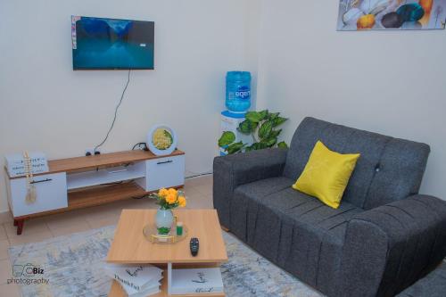 a living room with a couch and a table at Ferrum Apartments in Eldoret
