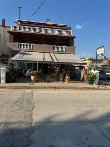 a building with awnings on the side of a street at Maria Apartments in Néa Karváli