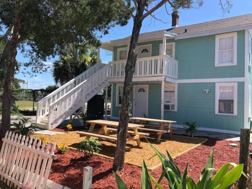 a house with a deck and a picnic table at Pets OK! Steps to Ocean Center Walk to Beach! in Daytona Beach