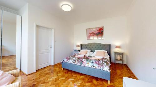 a bedroom with a bed in the middle of a room at Kangaroo Rooms in Pezinok