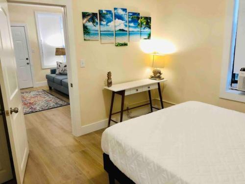 a bedroom with a bed and a table and a couch at PETS OK Steps 2 Ocean Center Walk 2 Beach in Daytona Beach