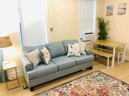 a living room with a blue couch and a table at Pets Ok Steps 2 Ocean Center Walk 2 Beach in Daytona Beach