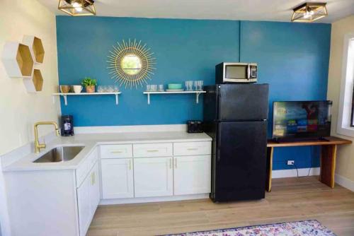 a kitchen with a black refrigerator and a sink at Pets Ok Steps 2 Ocean Center Walk 2 Beach in Daytona Beach