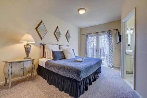 a bedroom with a bed and a table with a lamp at Pocono Retreat -1 Mile To Lake And Skiing! in Lake Harmony