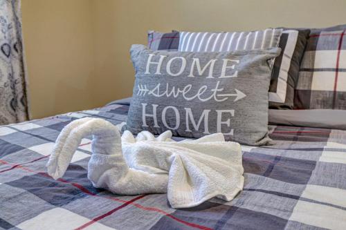 a swan towel laying on a bed with a pillow at Pocono Retreat -1 Mile To Lake And Skiing! in Lake Harmony