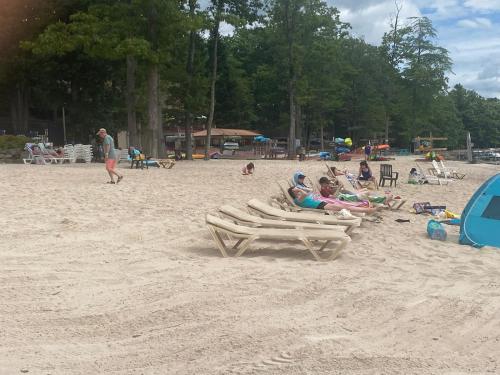 a group of people sitting in chairs on a beach at Pocono Retreat -1 Mile To Lake And Skiing! in Lake Harmony