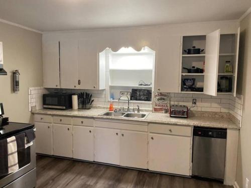 a kitchen with white cabinets and a sink at 3 Bedroom Cozy Home Minutes From Tims Ford Lake in Winchester